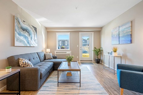 A living room with a grey couch and a coffee table.