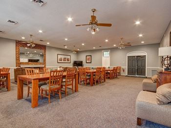 A spacious dining room with a fireplace and a brick wall.
