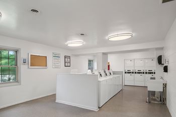 A white reception area with a counter and a window.