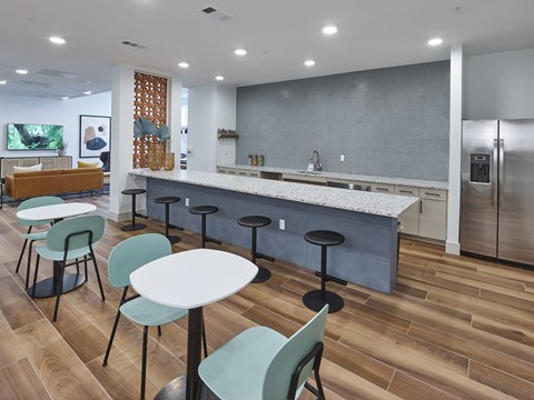 A modern kitchen with a bar area and seating.