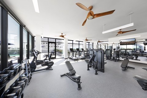 A gym with a variety of equipment including treadmills, weights, and exercise machines. at Altana, California