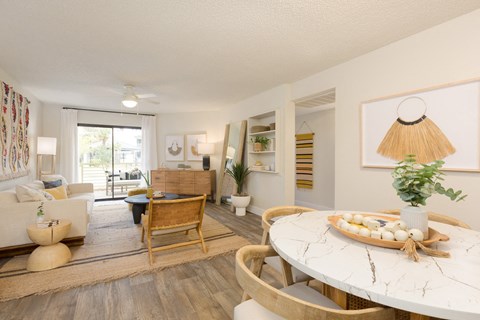 A living room with a white table and a wooden chair.