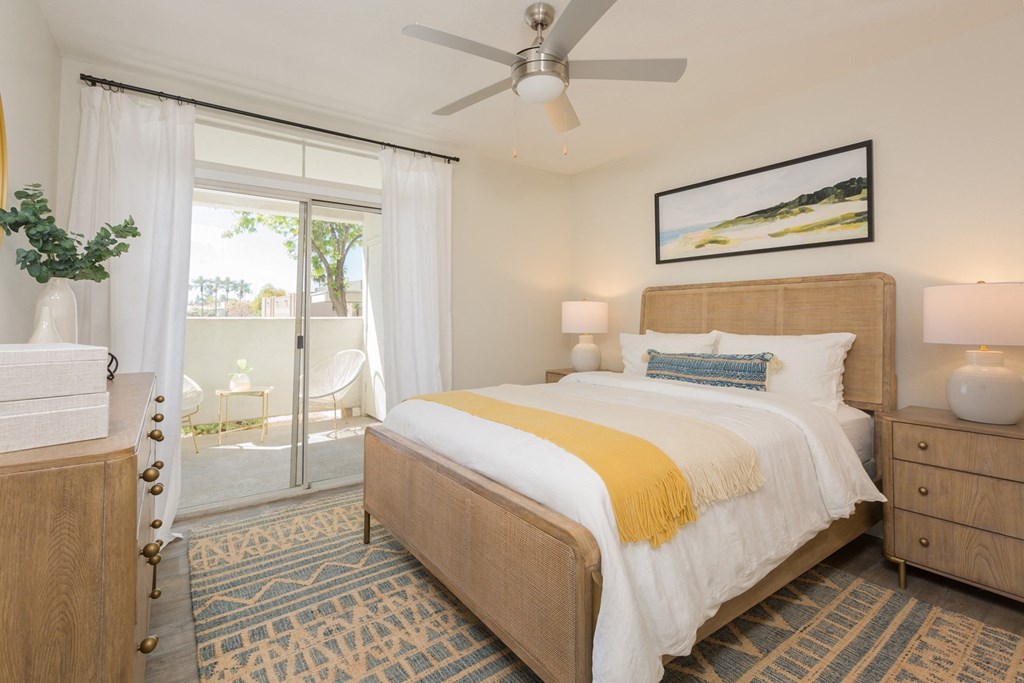 a bedroom with a bed and a ceiling fan