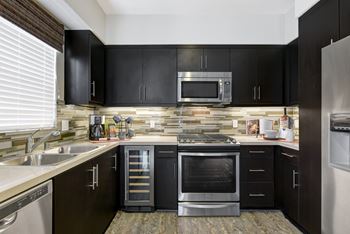 Soft Close Cabinets & Drawers in kitchen with black cabinets at Avino in San Diego, CA 92130