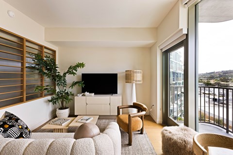 A living room with a couch, chair, and a television.