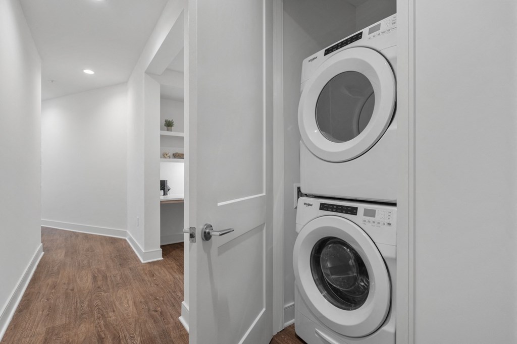 a washer and dryer in a laundry room with a white door at Stanza Little Italy, San Diego, CA