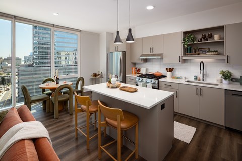 A modern kitchen with a dining table and chairs.