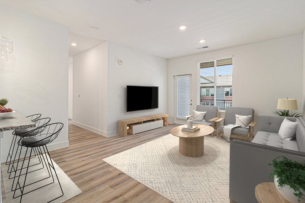 A modern living room with a television, sofas, and a dining table.