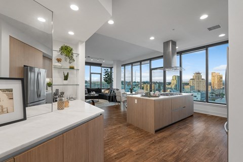 an open kitchen and living room with a view of the city