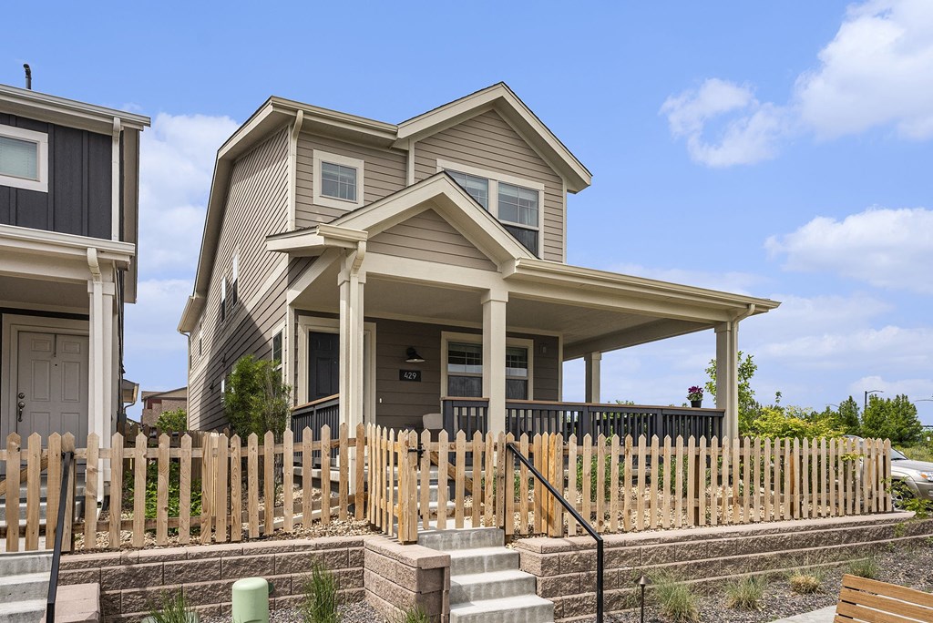 a house with a wooden fence in front of it