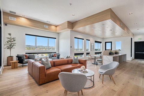 A modern living room with a large sectional sofa and a wooden coffee table.