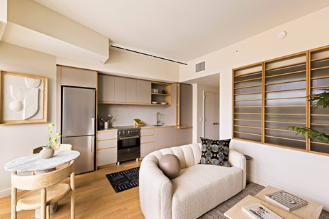 A modern kitchen with a dining table and a couch.