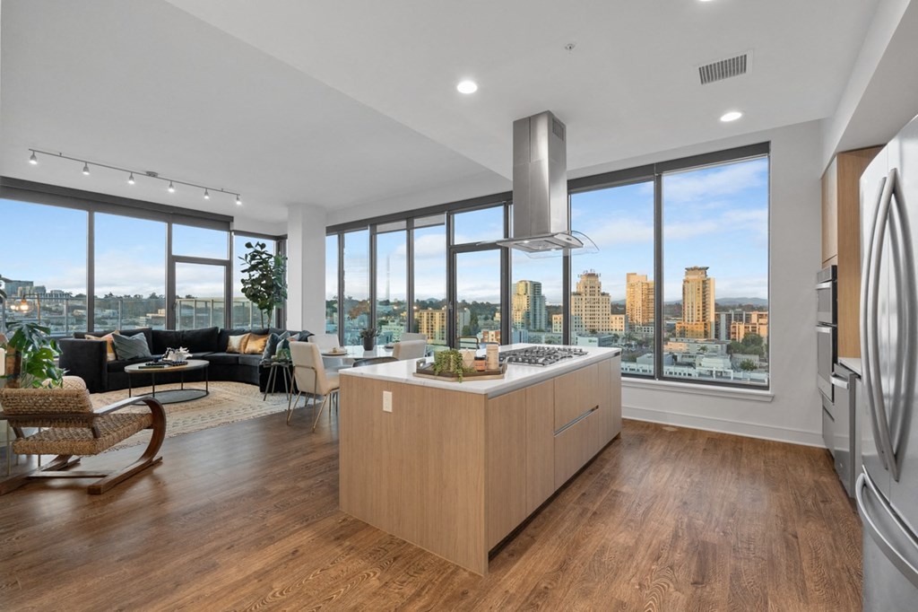 a kitchen with a large island next to a window with a city view at Stanza Little Italy, California, 92101