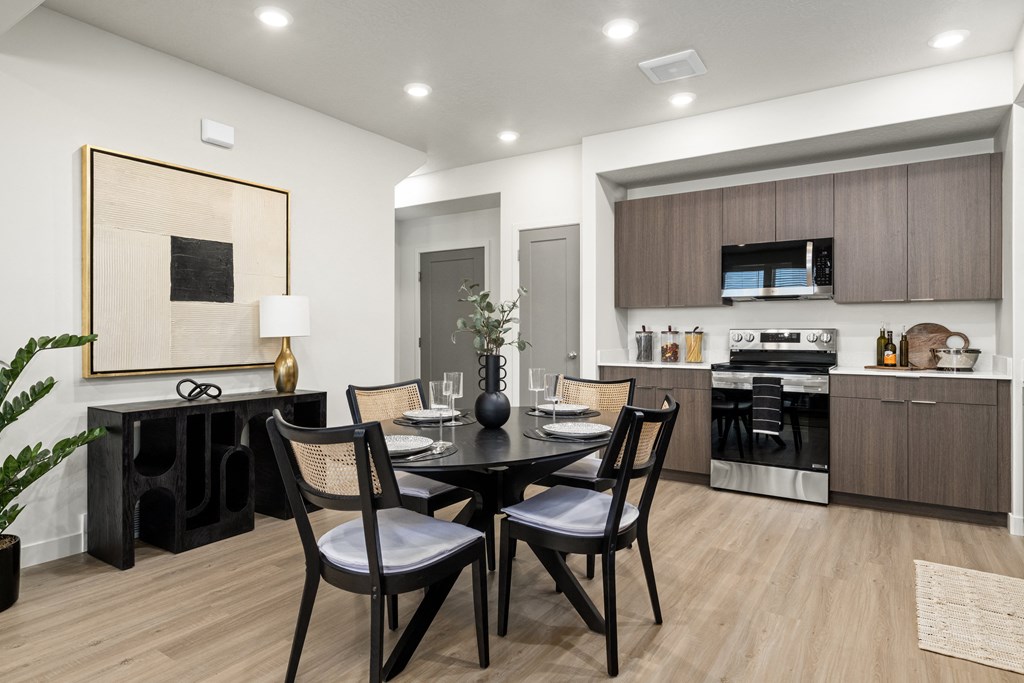 a kitchen and dining room with a table and chairs