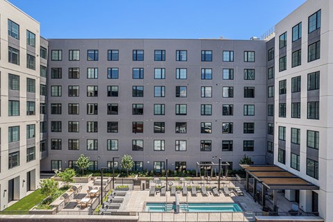 A large building with a pool in front.