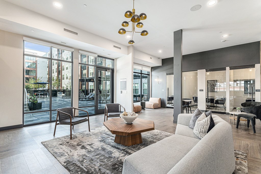 A modern living room with a grey sofa and a wooden coffee table.