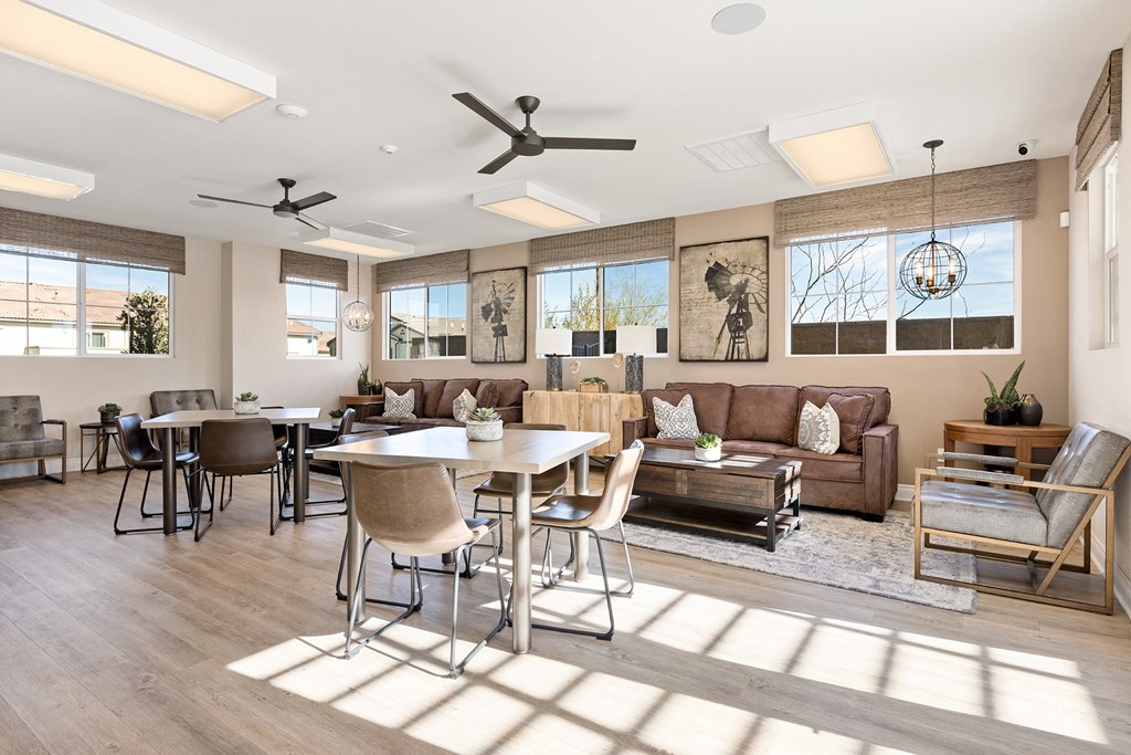 a living room with couches and chairs and a dining table