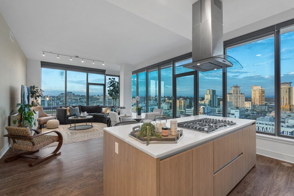 a kitchen with a large island in front of a window with a city view at Stanza Little Italy, San Diego, CA, 92101