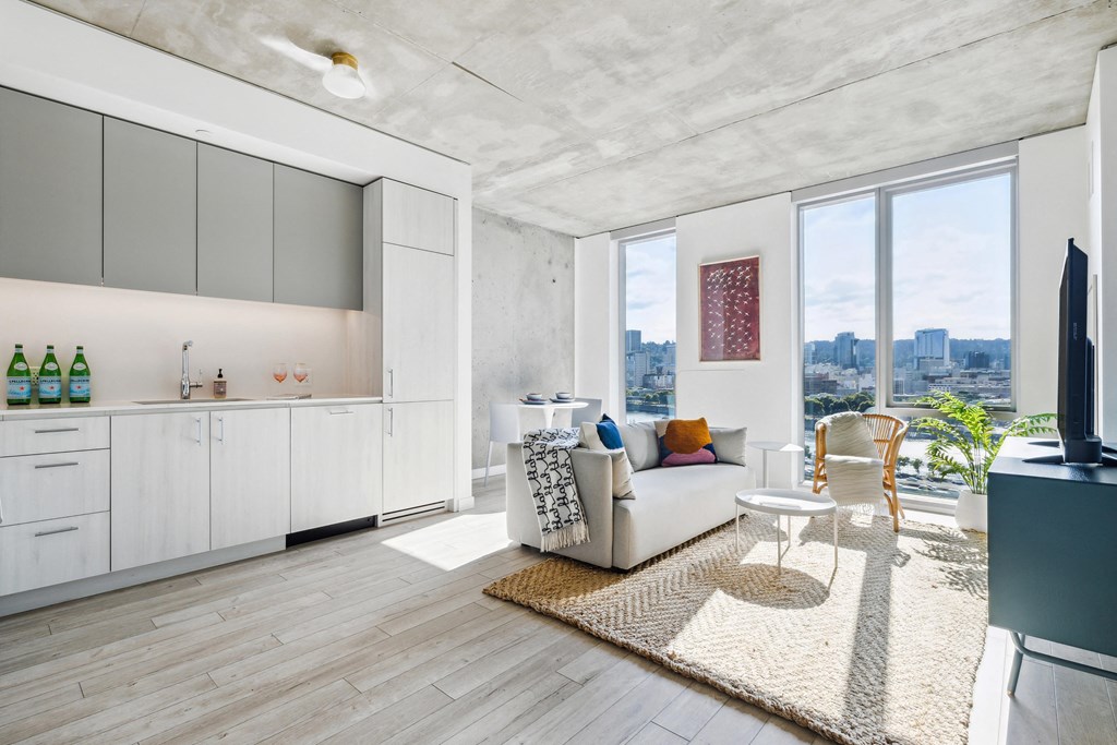 a living room with a white couch and a large window