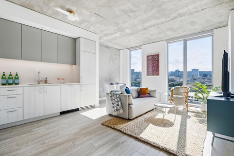 a living room with a white couch and a large window