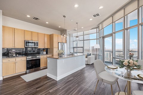 A modern kitchen with a dining table and chairs.