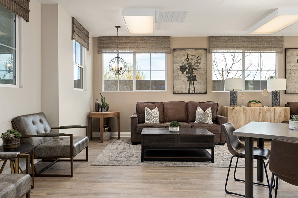 a living room with couches and chairs and a table