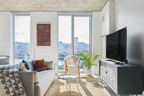 a living room with a white couch and a large window