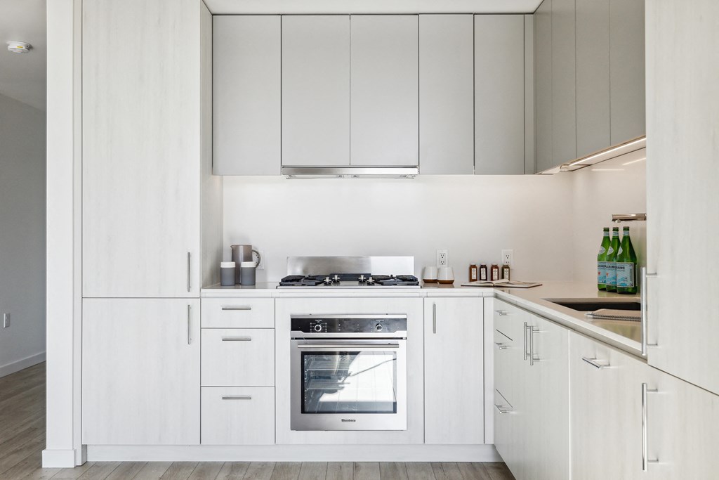 a kitchen with white cabinets and white appliances