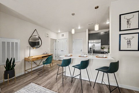A dining room with a white table and chairs.