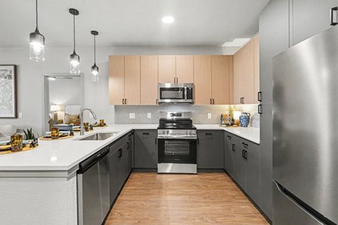 A modern kitchen with wooden cabinets and stainless steel appliances.