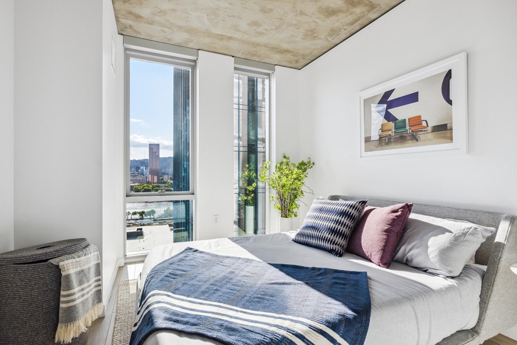 a bedroom with a large bed and a large window