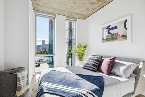 a bedroom with a large bed and a large window