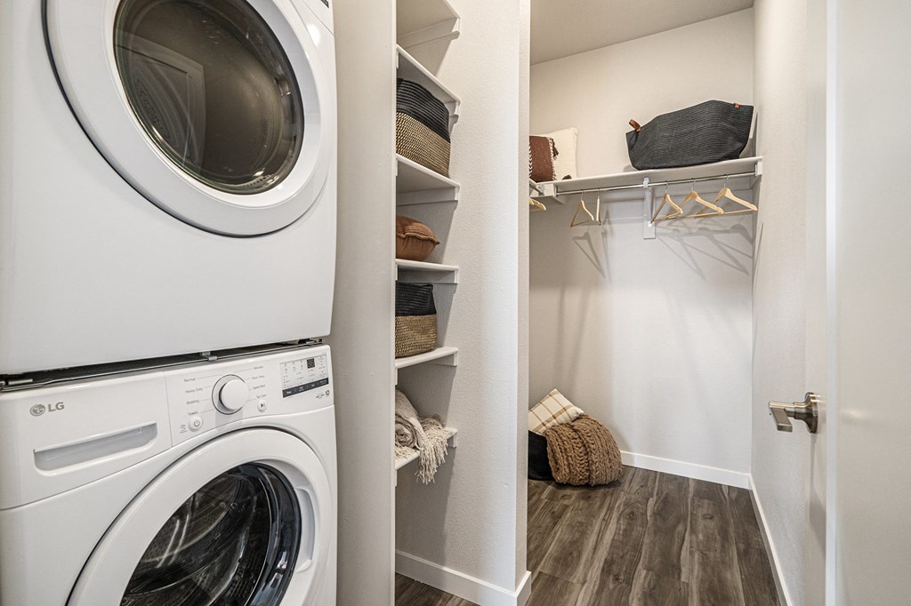 a washer and dryer in a laundry room with a closet