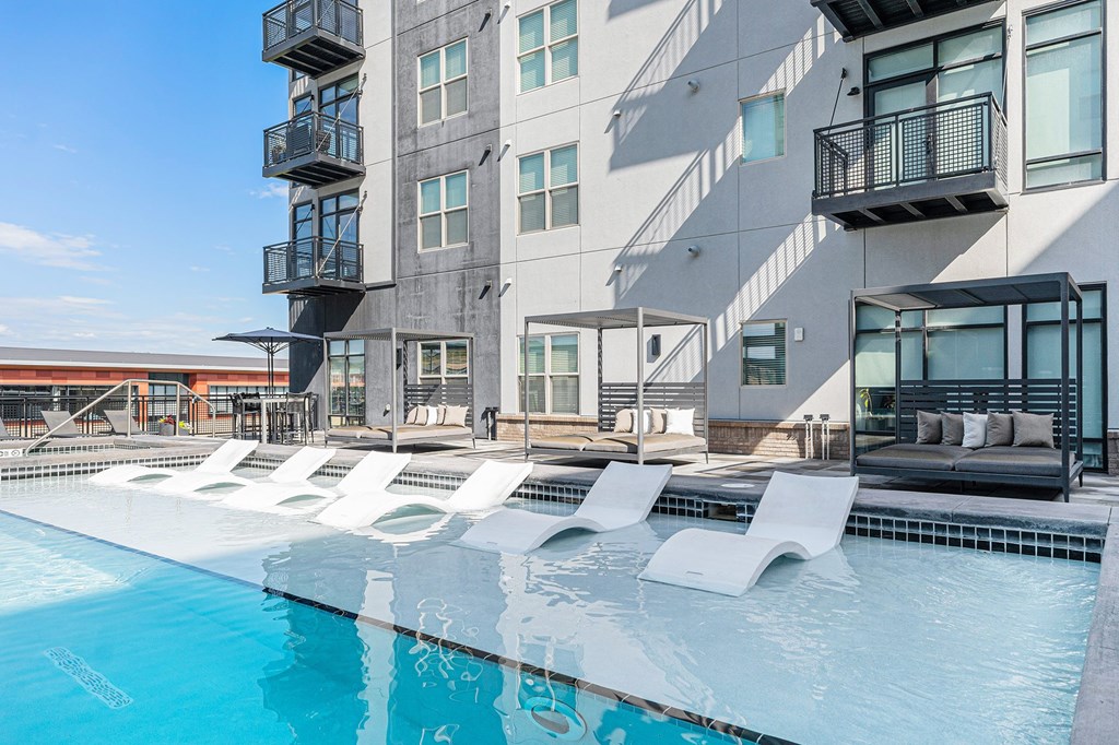 A modern building with a pool in front.