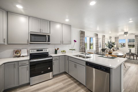 a kitchen with stainless steel appliances and white counter tops