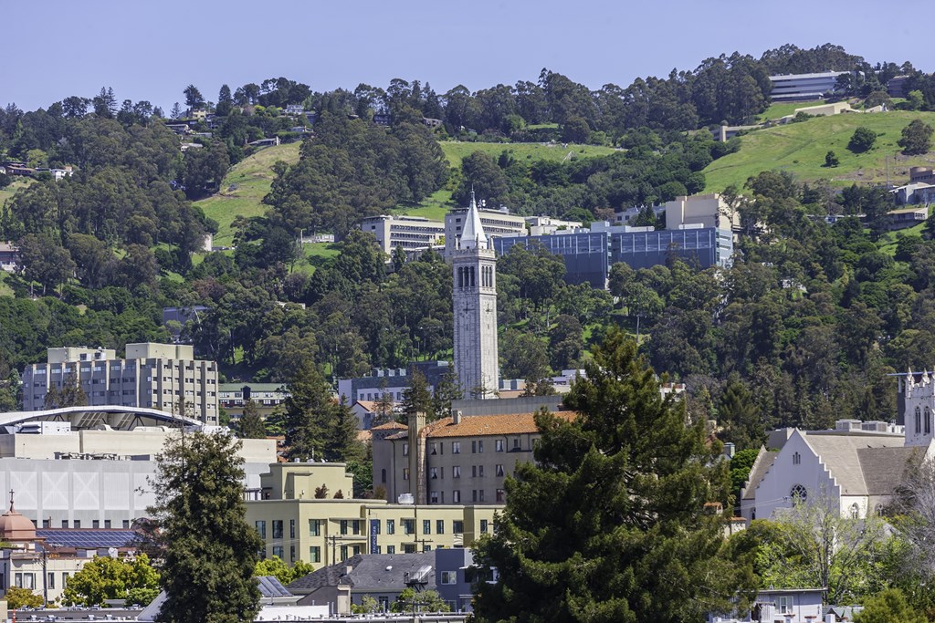 A cityscape with a prominent white tower in the center.