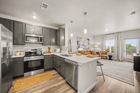 A modern kitchen with stainless steel appliances and a large island.