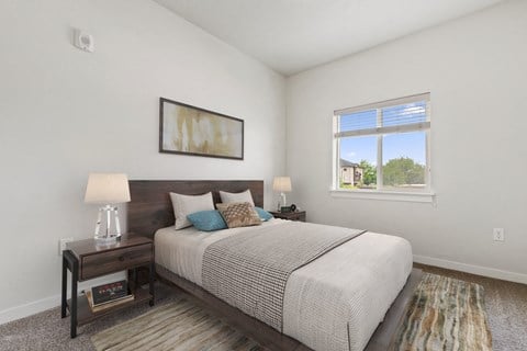 a bedroom with a large bed and two night stands with lamps