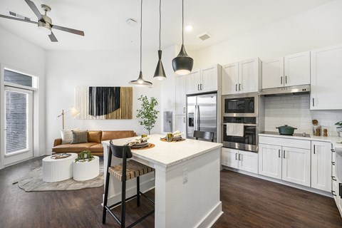 A modern kitchen with a dining table and chairs.