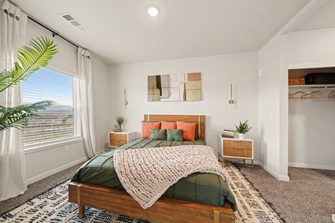 A bedroom with a large bed and a painting on the wall.