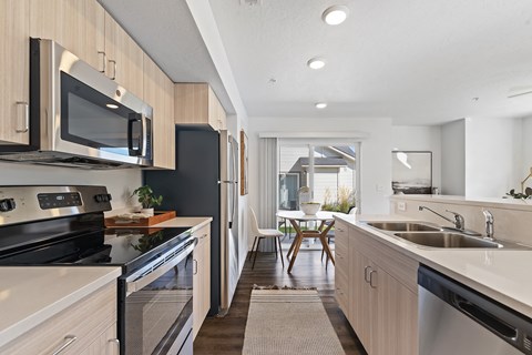 a modern kitchen with stainless steel appliances and wooden cabinets