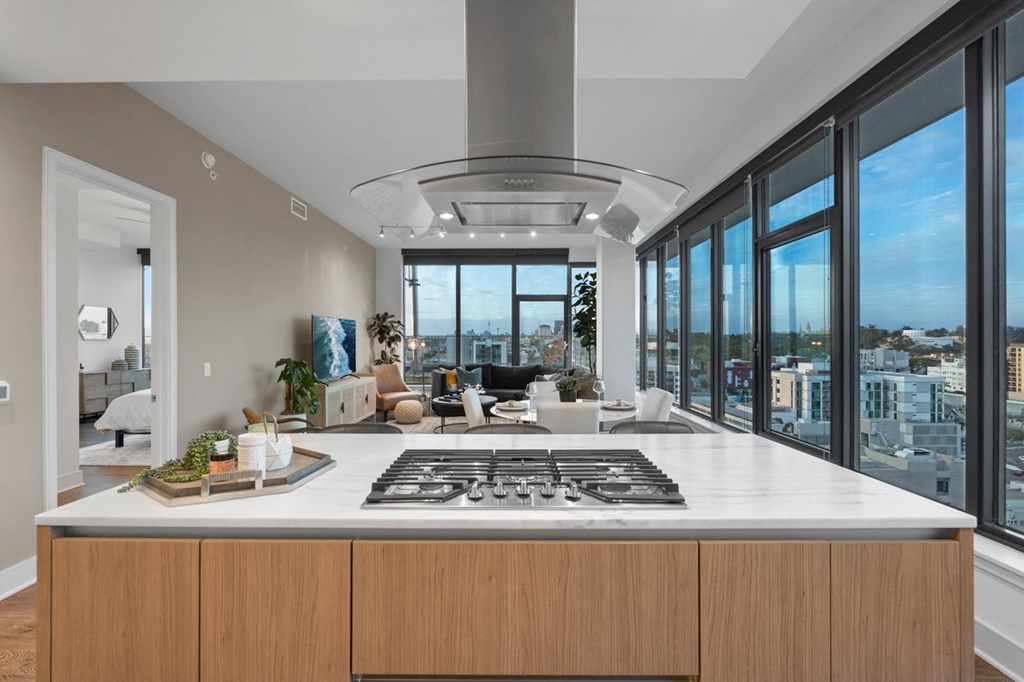 a kitchen with a large island and a view of a living room at Stanza Little Italy, California