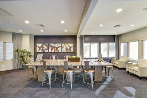 A conference room with a long table and chairs.