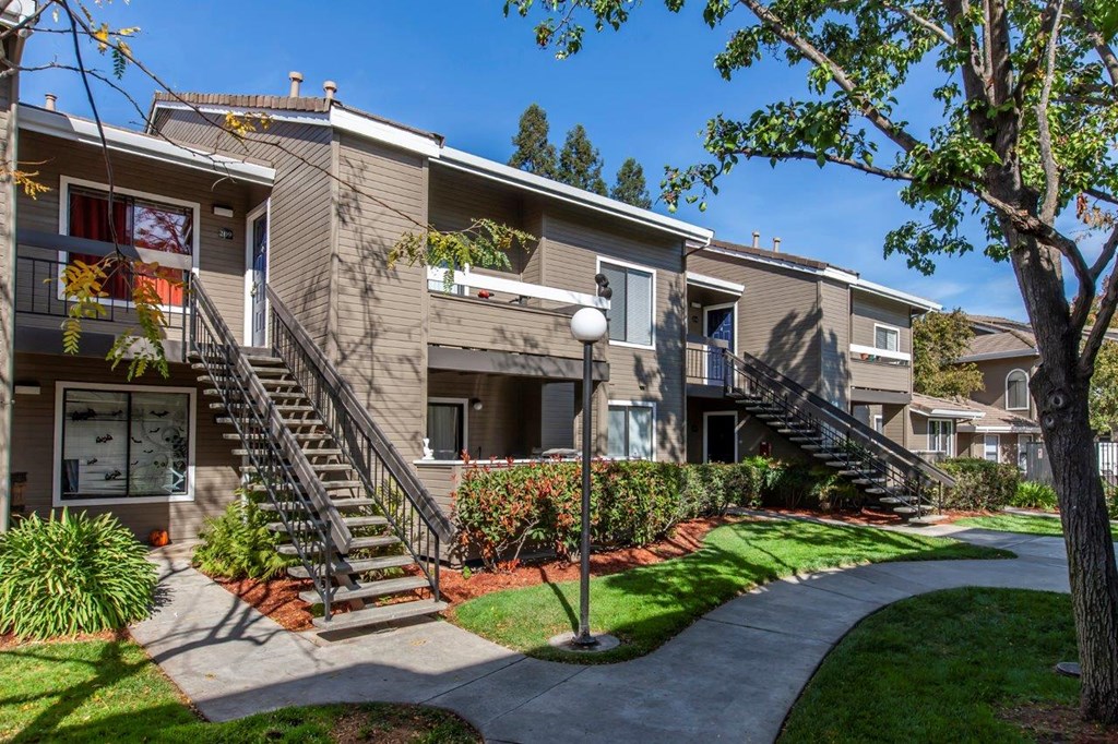 Pet Friendly Apartments in Morgan Hill CA - Monte Vista - Building Exteriors with Stairs, Greenery, and Pathway