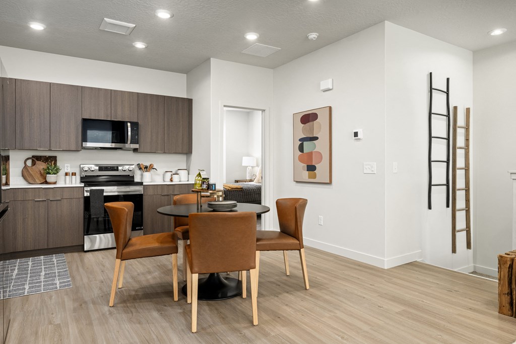 a living room and dining room with a table and chairs