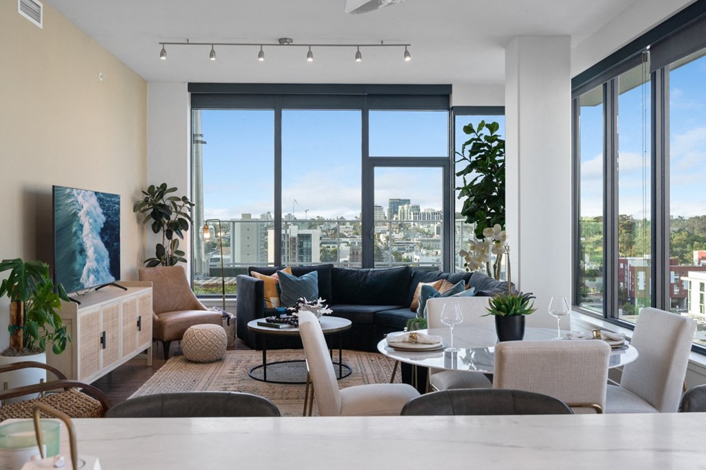 a living room with a large window and a view of a city at Stanza Little Italy, California, 92101