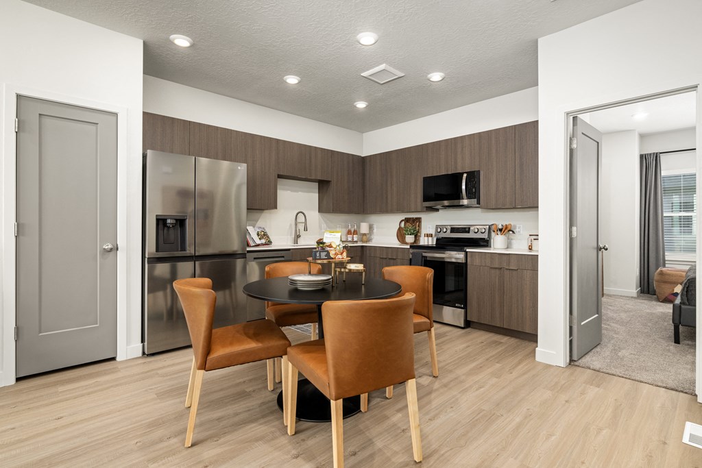 a kitchen and dining room with a table and chairs