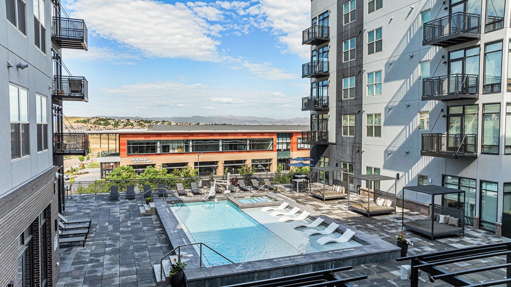 A large outdoor pool surrounded by buildings.