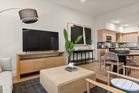 A living room with a television and a dining area.