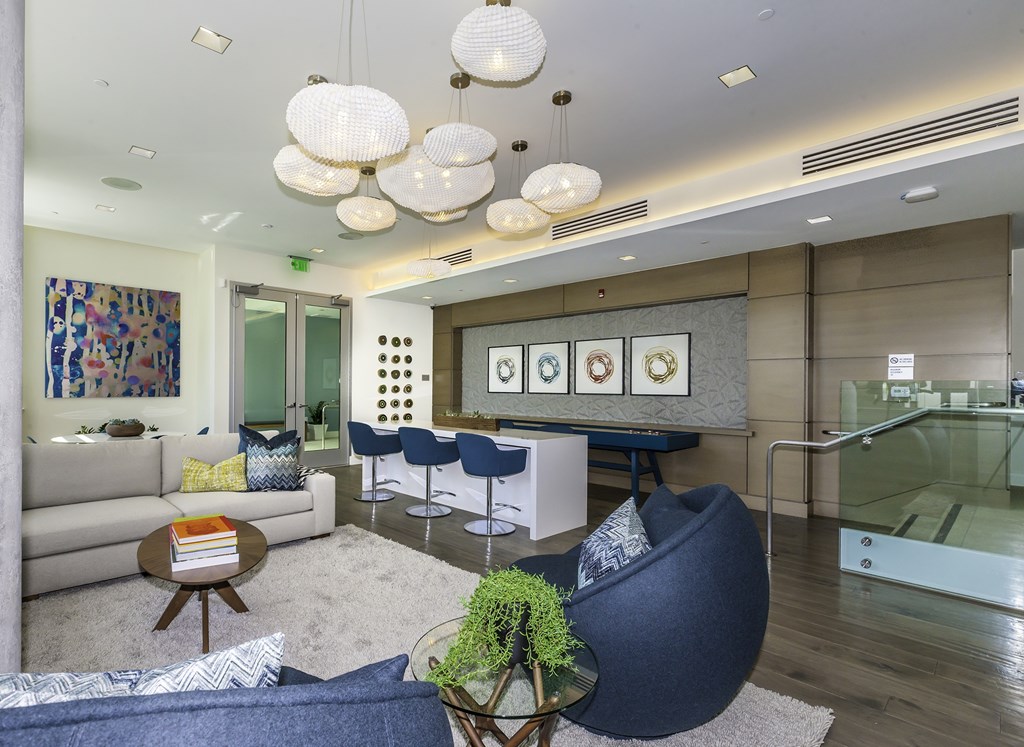 A modern living room with a blue chair and a coffee table.